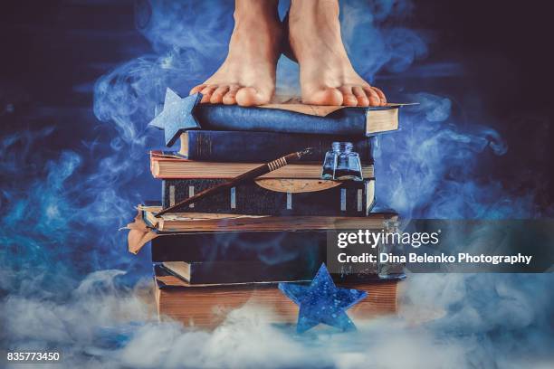 kid standing on a pile of books in the middle of a cloud of smoke. - entertainment book edit stock pictures, royalty-free photos & images