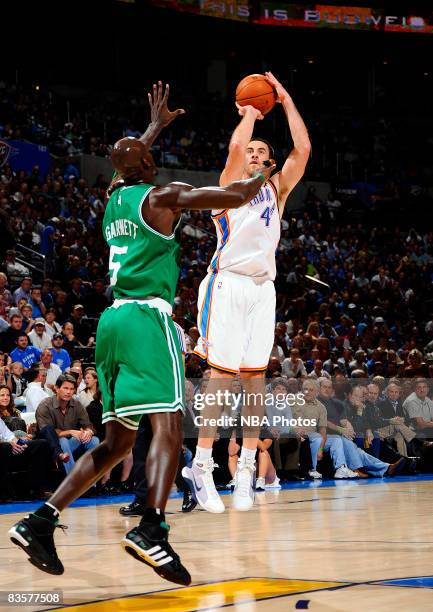 Nick Collison of the Oklahoma City Thunder shoots a jumps shot against Kevin Garnett of the Boston Celtics at the Ford Center on November 5, 2008 in...