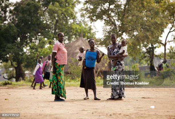 Rhino, Uganda Young women stand with their children on a place at the Rhino Refugee Camp Settlement in northern Uganda. The area is home to about...