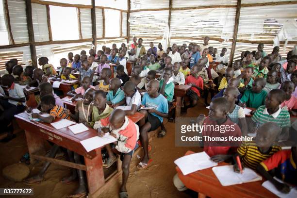 Group of students in a school at the Rhino Refugee Camp Settlement in northern Uganda. Here, children of local people and refugees are taught...