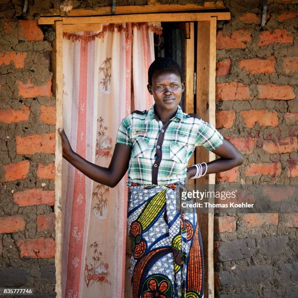 Portrait of a young woman in front of the entrance of her hut at the Rhino Refugee Camp Settlement in northern Uganda. The area is home to about...