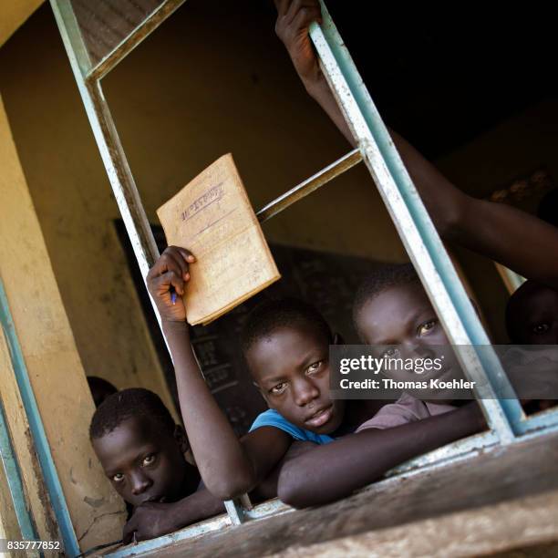 Rhino, Uganda Students are looking out of an open window of a school at Rhino Refugee Camp Settlement in northern Uganda. Here, children of local...