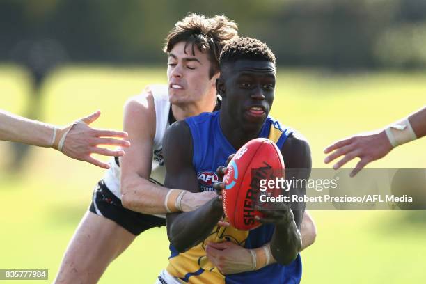 Buku Khamis of the Western Jets is tackled during the TAC Cup round 16 match between the Northern Knights and the Western Jets at RAMS Arena on...
