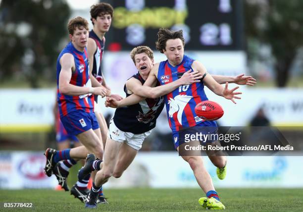 Lachlan Bugeja of the Oakleigh Chargers is tackled during the TAC Cup round 16 match between the Oakleigh Chargers and the Sandringham Dragons at...