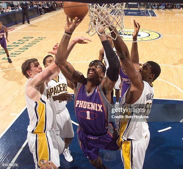 Amare Stoudemire of the Phoenix Suns battles Troy Murphy, Roy Hibbert of the Indiana Pacers at Conseco Fieldhouse on November 5, 2008 in...