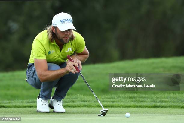 Johan Carlsson of Sweden lines up a putt on the 1st green during the 3rd/4th place playoff match of the Saltire Energy Paul Lawrie Matchplay at Golf...