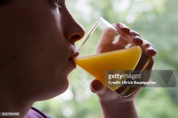 Vitamin C - Allroundgenie in terms of human health. Young man drinking a glass of orange juice.