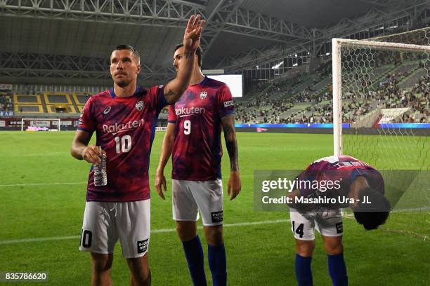 Lukas Podolski, Mike Havenaar and Naoyuki Fujita of Vissel Kobe Vissel Kobe applaud supporters after the scoreless draw in the J.League match between...