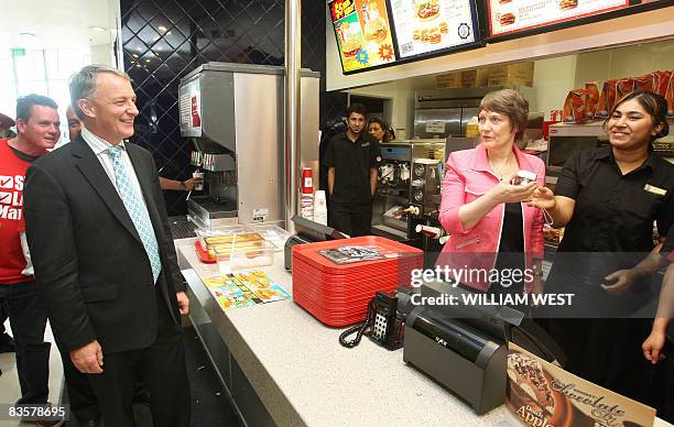 New Zealand's Minister of Defence Phil Goff , jokingly orders a meal from Labour Prime Minister Helen Clark standing behind the counter of a fastfood...