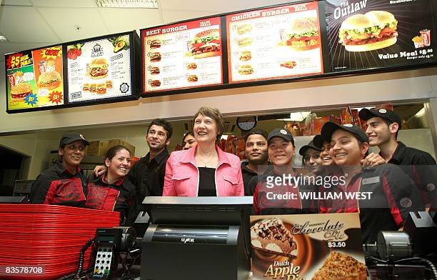 New Zealand's Labour Prime Minister Helen Clark poses with staff behind the counter of a fastfood outlet during a tour of a shopping centre in the...