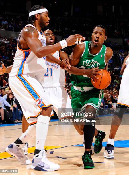 Tony Allen of the Boston Celtics goes to the basket while being guarded by Chris Wilcox and Damien Wilkins of the Oklahoma City Thunder at the Ford...