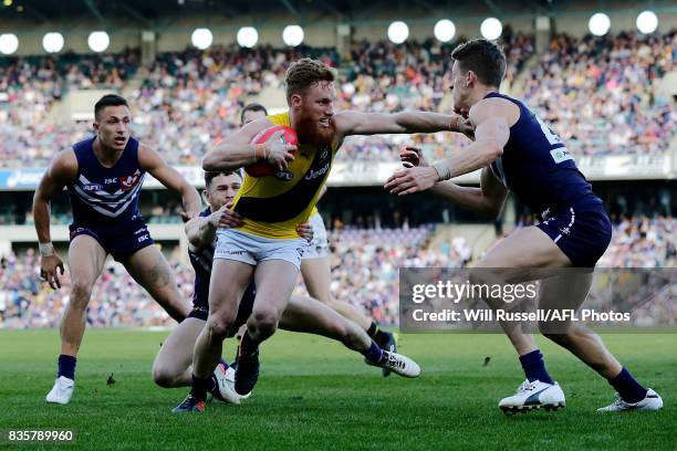 Nick Vlastuin of the Tigers fends off Matt Taberner of the Dockers during the round 22 AFL match between the Fremantle Dockers and the Richmond...