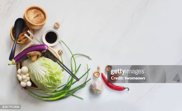 chinese uncooked vegan food and eating utensils on marble table top. - vegan food white background stock pictures, royalty-free photos & images