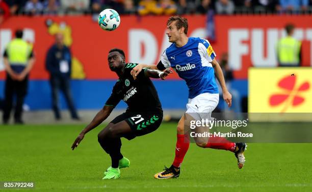 Christopher Lenz of Kiel and Khaled Narey of Greuther Fuerth battle for the ball during the Second Bundesliga match between Holstein Kiel and SpVgg...