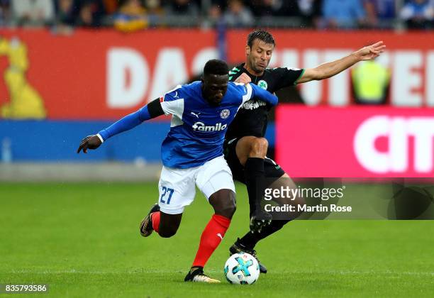 Kingsley Schindler of Kiel and Marco Caligiuri of Greuther Fuerth battle for the ball during the Second Bundesliga match between Holstein Kiel and...