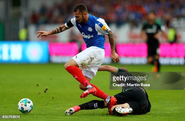 Dominik Schmidt of Kiel and Philipp Hofmann of Greuther Fuerth battle for the ball during the Second Bundesliga match between Holstein Kiel and SpVgg...