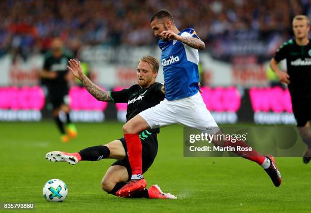 Dominik Schmidt of Kiel and Philipp Hofmann of Greuther Fuerth battle for the ball during the Second Bundesliga match between Holstein Kiel and SpVgg...
