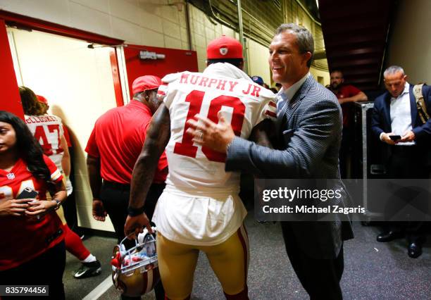 Louis Murphy of the San Francisco 49ers is congratulated by General Manager John Lynch outside the locker room following the game against the Kansas...