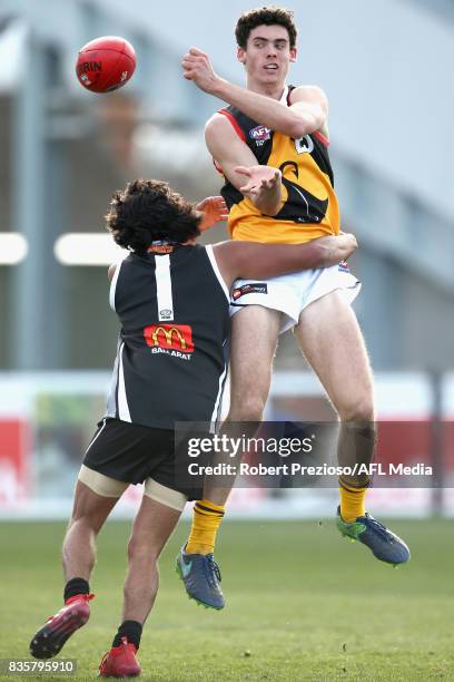 Oscar Clavarino of the Dandenong Stingrays handballs during the TAC Cup round 16 match between the Greater Western Victoria Rebels and the Dandenong...