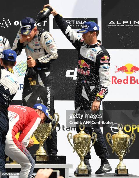 3rd place Sebastien Ogier and his co-driver Julien Ingrassia of France celebrate during the flower ceremony after the WRC Germany on August 20, 2017...