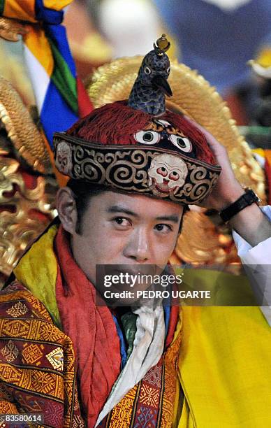 The new king of Bhutan, Jigme Khesar Namgyel Wangchuck, holds his crown at the Tashichho Dzong Palace in Thimphu on November 6, 2008. The isolated...