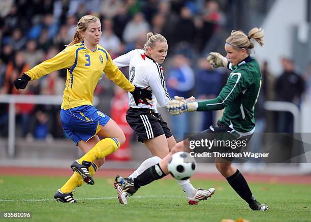 Isabel Kerschowski of Germany battles for the ball with Linda Sembrandt and goalkeeper Maria Cederholm of Sweden during the women international...