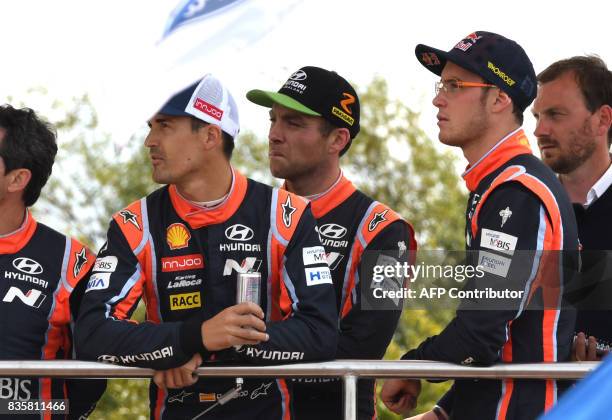 Dani Sordo of Spain , hayden Paddon of New Zealand and Thierry Neuville of Belgium follow the flower ceremony during the WRC Germany on August 20,...