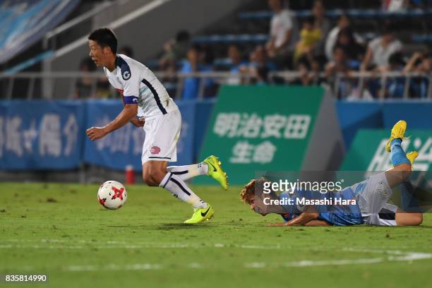 Ryohei Hayashi of Mito Hollyhock and Kensuke Sato compete for the ball during the J.League J2 match between Yokohama FC and Mito Hollyhock at...