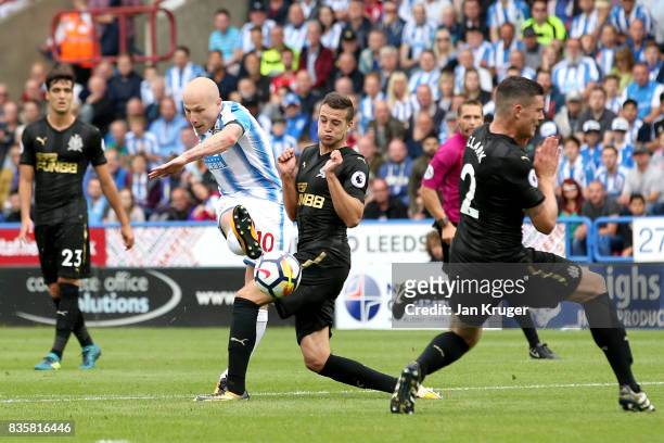 Aaron Mooy of Huddersfield Town scores his sides first goal during the Premier League match between Huddersfield Town and Newcastle United at John...