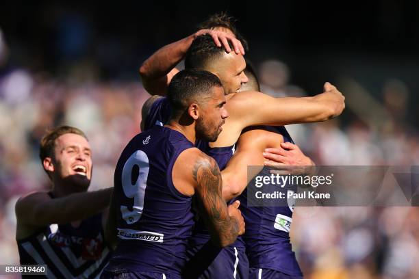 Harley Bennell of the Dockers celebrates a goal with team mates during the round 22 AFL match between the Fremantle Dockers and the Richmond Tigers...