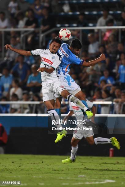 Ryoji Fukui of Mito Hollyhock and Ibba compete for the ball during the J.League J2 match between Yokohama FC and Mito Hollyhock at Nippatsu Mitsuzawa...