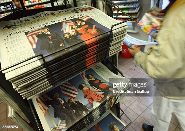 German newspapers showing triumphant U.S. Presidential candidate Barack Obama stand in a news kiosk the day after election results confirmed Obama's...