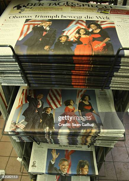 German newspapers showing triumphant U.S. Presidential candidate Barack Obama stand in a news kiosk the day after election results confirmed Obama's...