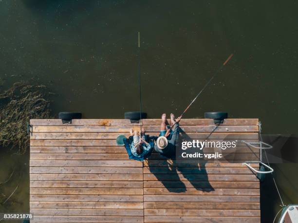 family fishing on jetty - lake fishing stock pictures, royalty-free photos & images