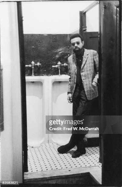 American poet and playwright LeRoi Jones leans against the door of a bathroom stall the day of his play 'The Toilet' debuted at the St. Marks...