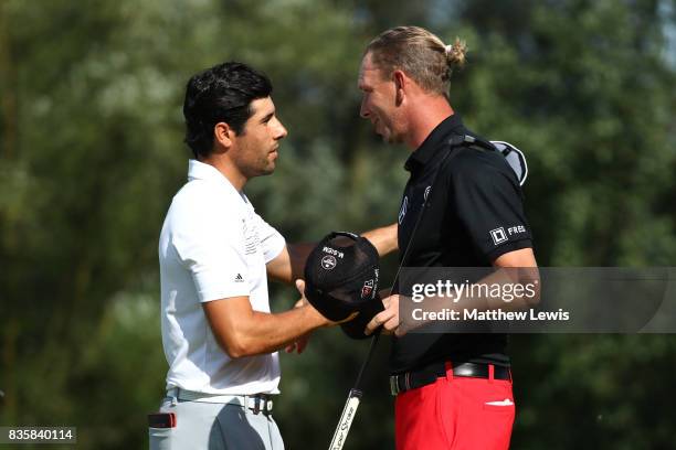 Adrian Otaegui of Spain is congratulated on his victory by Marcel Siem of Germany on the 17th green during the final match of the Saltire Energy Paul...