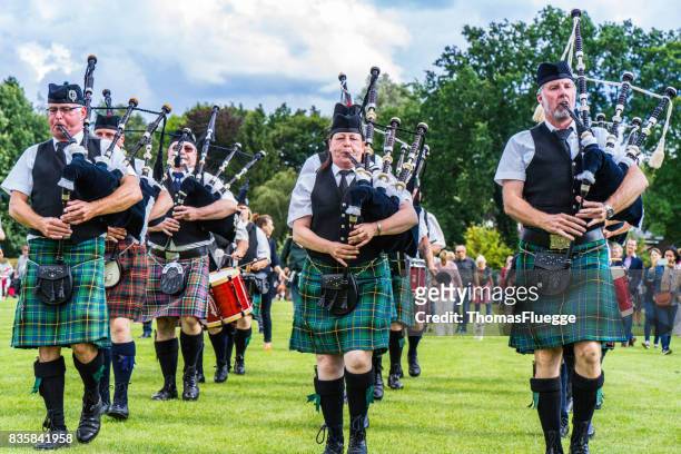 pipers in brass band at british flair in hamburg - germany vs scotland stock pictures, royalty-free photos & images