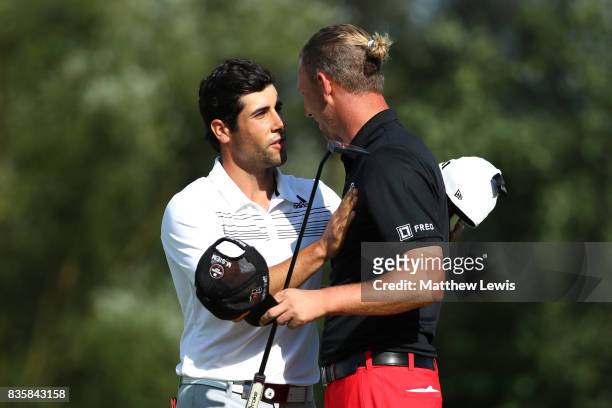 Adrian Otaegui of Spain is congratulated on his victory by Marcel Siem of Germany on the 17th green during the final match of the Saltire Energy Paul...