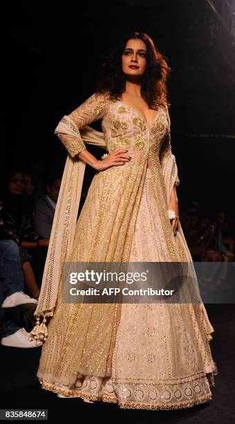 Indian Bollywood actress Dia Mirza showcases a creation by designer Faabhana at the Lakme Fashion Week Winter/Festive 2017 in Mumbai on August 20,...