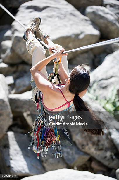 female climber does a tyrolean traverse - boulder colorado stock pictures, royalty-free photos & images