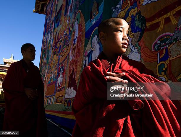 Bhutanese monks stand next to a large Thangkha painting at the Dratshang Kuenra Tashichho Dzong waiting for His Majesty Jigme Khesar Namgyel...