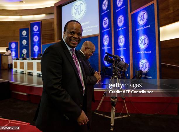 King Mswati III of the Kingdom of Swaziland and South Africa's President Jacob Zuma share a light moment as they depart from the closing ceremony of...