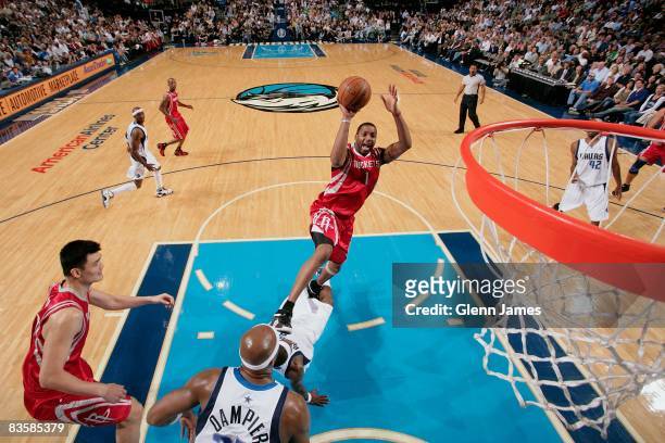 Tracy McGrady of the Houston Rockets puts up a shot against Erick Dampier of the Dallas Mavericks during the game on October 30, 2008 at the American...
