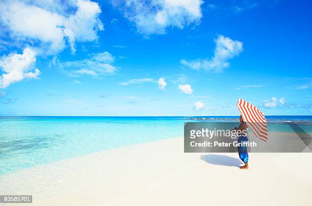 woman standing with umbrella - anguilla photos et images de collection