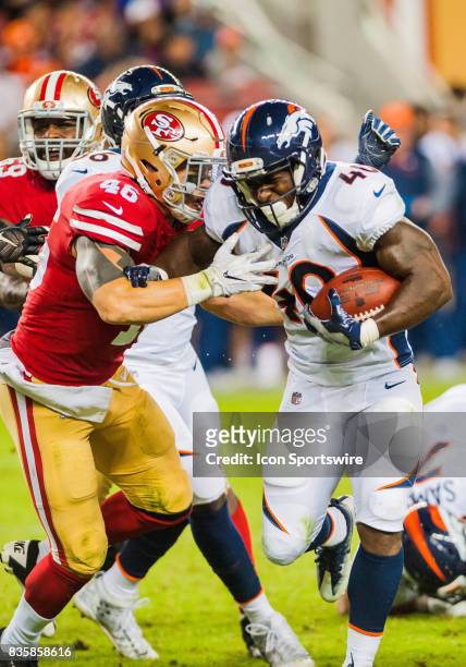 Denver Broncos running back Juwan Thompson tries to stiff arm San Francisco 49ers tight end Cole Hikutini as he races towards the end zone for a...