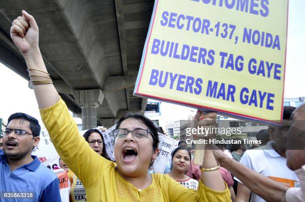 Hundreds of home buyers stage a protest against alleged delay in several home projects, on August 20, 2017 in Noida, India. The homebuyers urged...
