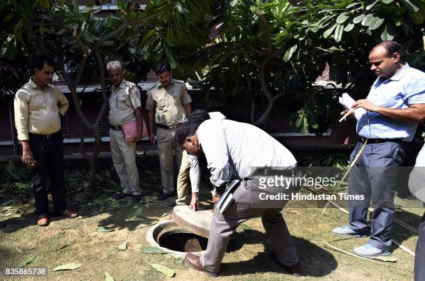 Delhi Police officers investigating the sewer where Rishi Pal was dead and left three people unconscious during sewer cleaning at Lok Nayak Jai...