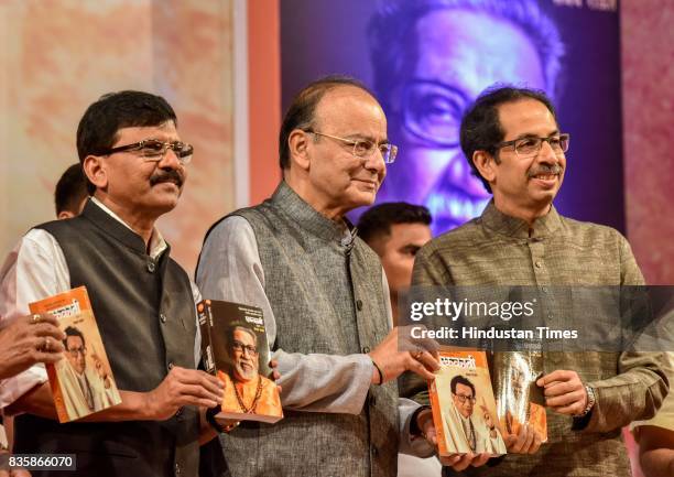 Shiv Sena MP Sanjay Raut, Union Minister Arun Jaitley and Shiv Sena Chief Uddhav Thackeray during the release of a compilation of a hundred...