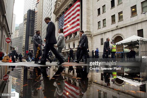 People walk by the New York Stock Exchange November 6, 2008 in New York City. Worries about the economy still dominate post-election America as the...