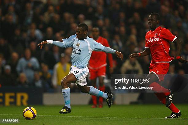 Shaun Wright-Phillips of Manchester City breaks clear of Cheick Tiote of FC Twente to score the opening goal during the UEFA Cup Group A match...